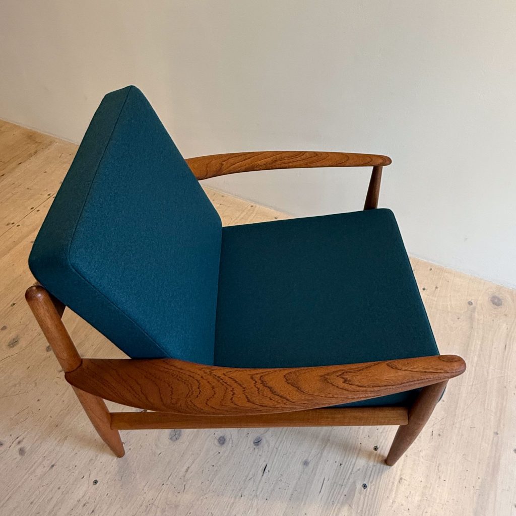 France & Daverkosen Teak Lounge Chair Model 118 by Grete Jalk. Produced in Denmark in the 1950s. Reupholstered with high quality Danish wool in petrol green.