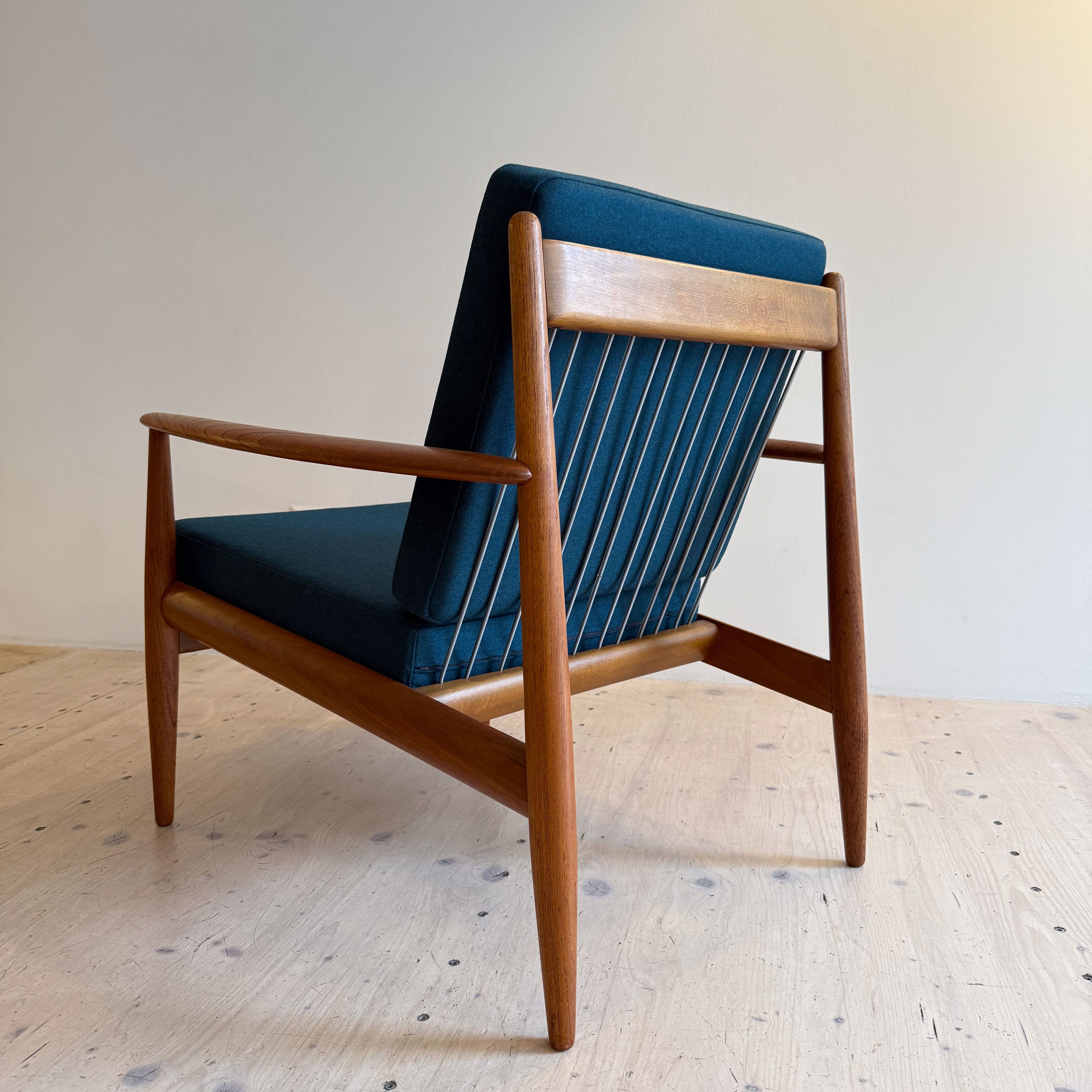 France & Daverkosen Teak Lounge Chair Model 118 by Grete Jalk. Produced in Denmark in the 1950s. Reupholstered with high quality Danish wool in petrol green.