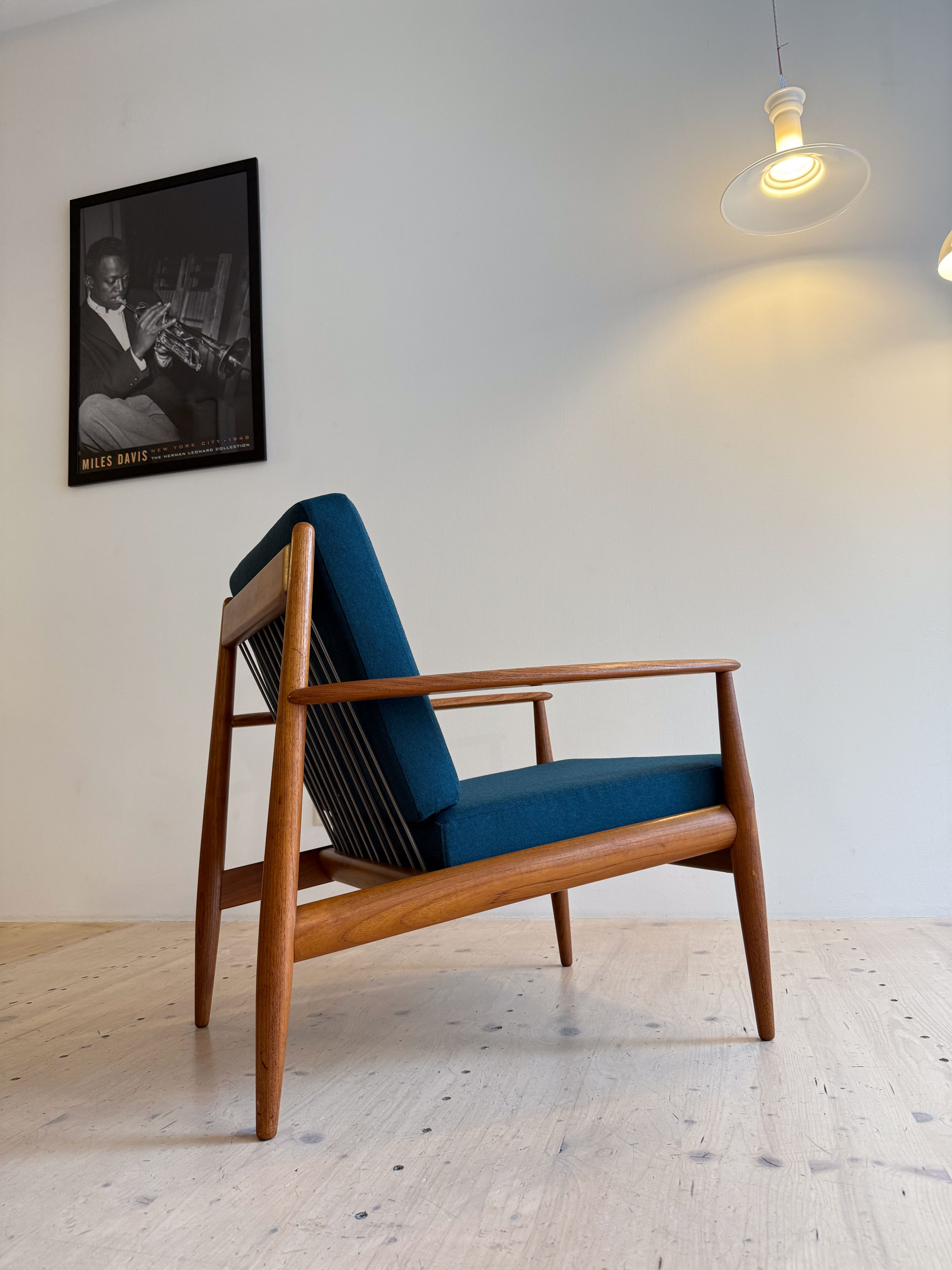 France & Daverkosen Teak Lounge Chair Model 118 by Grete Jalk. Produced in Denmark in the 1950s. Reupholstered with high quality Danish wool in petrol green.