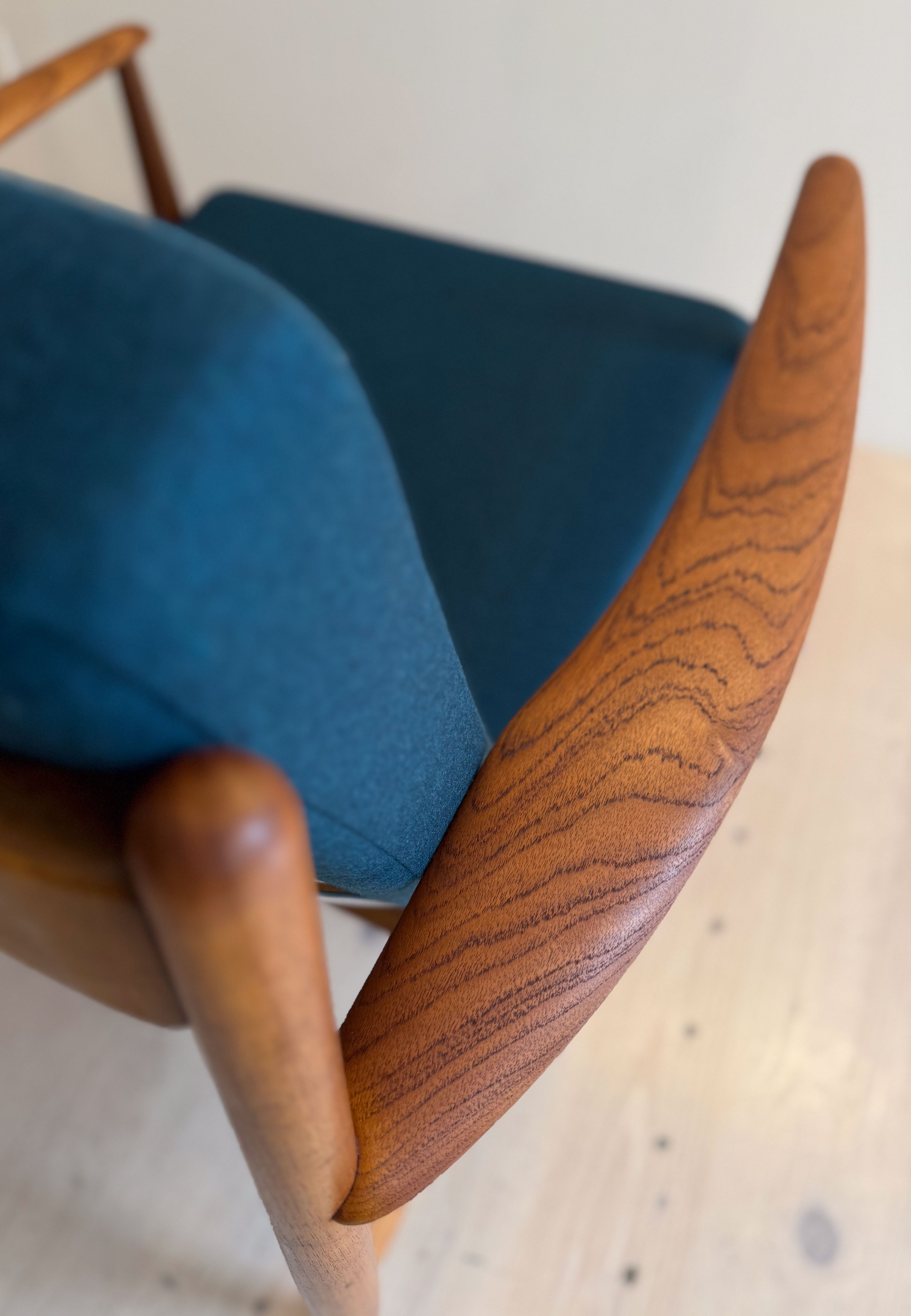 France & Daverkosen Teak Lounge Chair Model 118 by Grete Jalk. Produced in Denmark in the 1950s. Reupholstered with high quality Danish wool in petrol green.